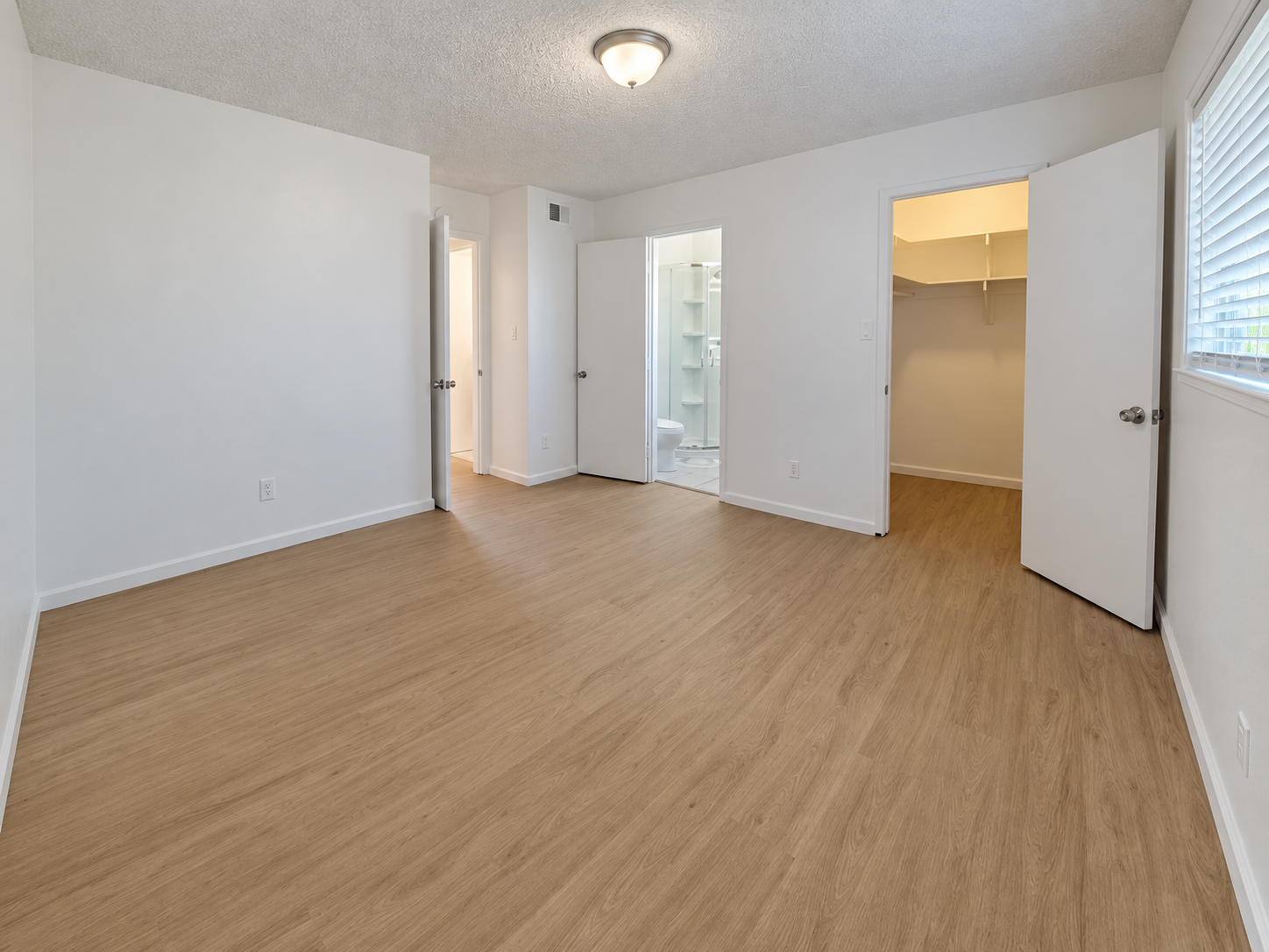 Unfurnished bedroom with private closet and bathroom access