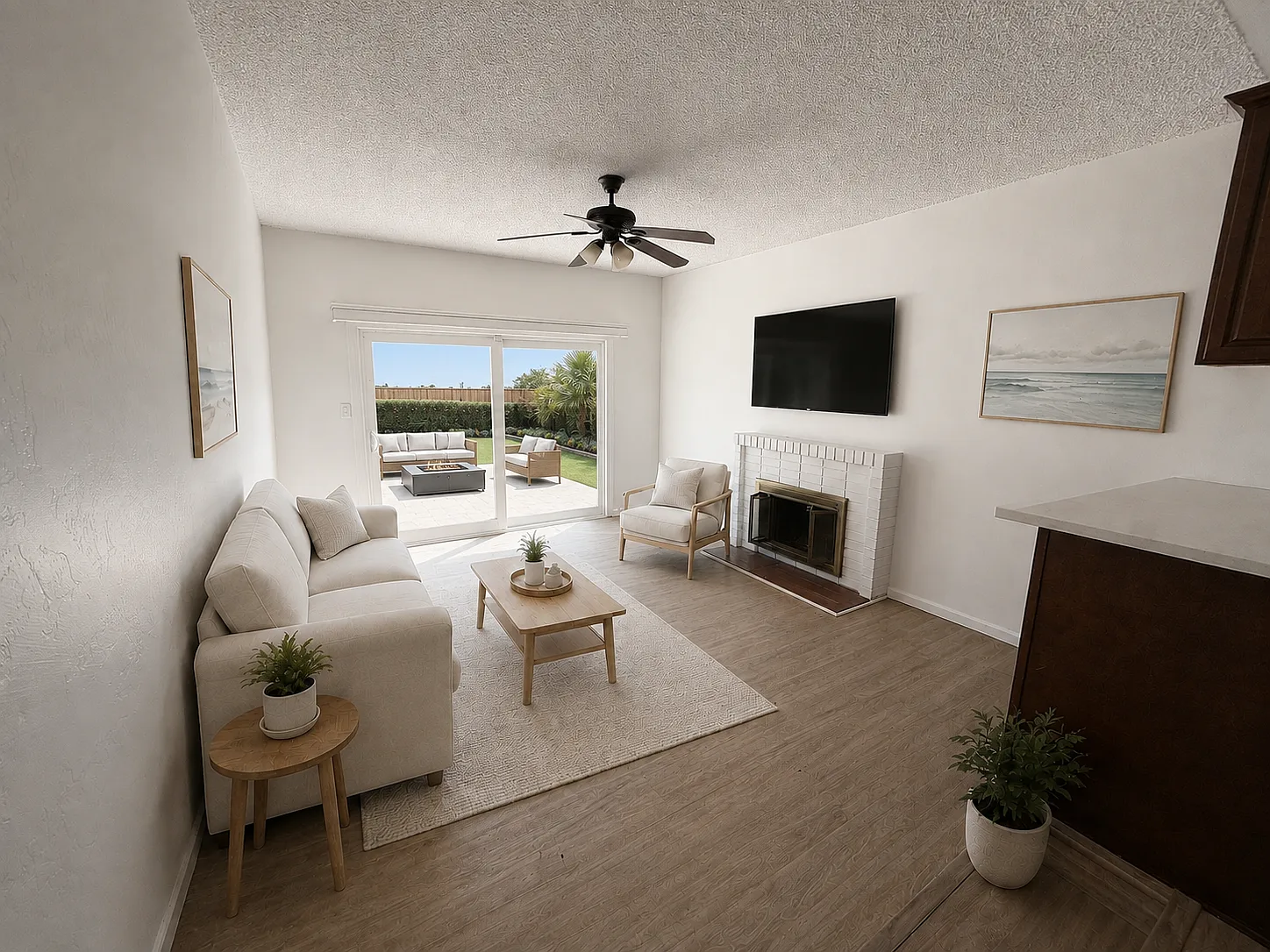 Virtually staged living room with seating and fireplace; furnishings are illustrative